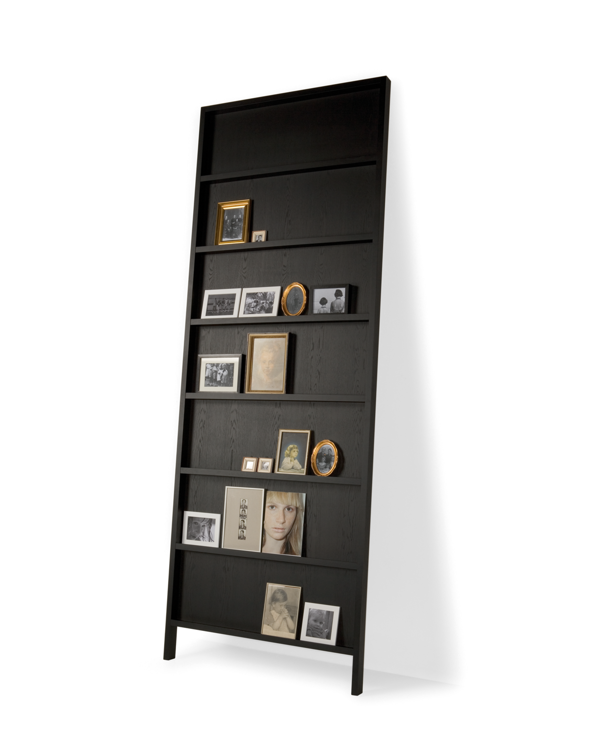 Oblique bookshelf big black stained wood front view with picture frames